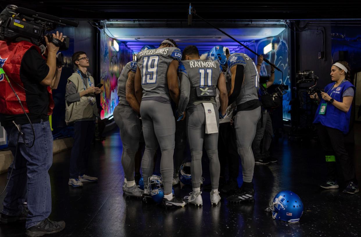 Detroit Lions receivers including Donovan Peoples-Jones and Kalif Raymond pray before the game against the Minnesota Vikings at Ford Field in Detroit on Sunday, Jan. 7, 2024.