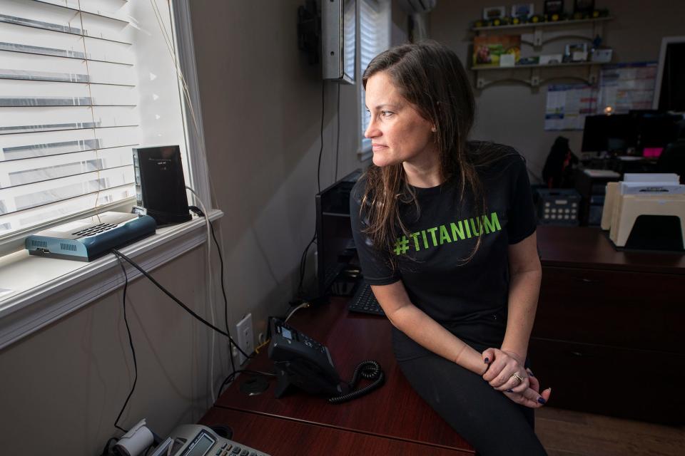 Carrie Almony looks out a window past a Verizon cellular modem that provides all of the internet data for her family's  business, Almony's Property Solutions, located outside of Glen Rock. A cellular connection is her only option to access the internet.
