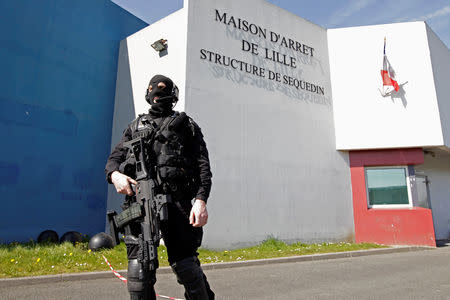 FILE PHOTO: A special police officer stands guard in front the jail of Sequedin near Lille, northern France April 14, 2013. Redoine Faid, an inmate, used explosives and took hostages to escape out of jail on Saturday morning, local media reported. REUTERS/Pascal Rossignol/File Photo