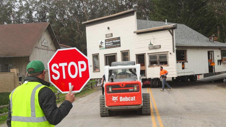 Steven Bishop stops traffic as Sebastian’s General Store is returned to its old location on a new foundation in San Simeon on Jan. 31, 2022. David Middlecamp/dmiddlecamp@thetribunenews.com