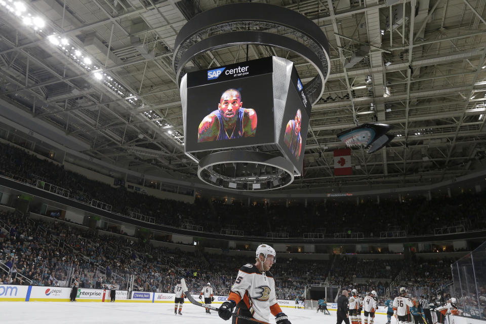 Anaheim Ducks right wing Ondrej Kase, bottom, skates under a video tribute to Kobe Bryant during a timeout in the first period of an NHL hockey game between the San Jose Sharks and the Ducks in San Jose, Calif., Monday, Jan. 27, 2020. (AP Photo/Jeff Chiu)