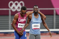 Isaiah Jewett, of the United States, and Nijel Amos, right, of Botswana, shake hands after falling in the men's 800-meter semifinal at the 2020 Summer Olympics, Sunday, Aug. 1, 2021, in Tokyo. (AP Photo/Jae C. Hong)