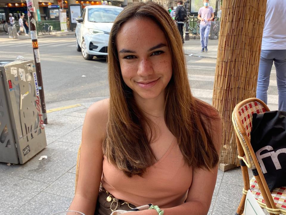 Kyra Alessandrini sitting at table in paris