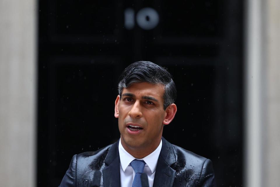 A soggy Mr Sunak announces his election in the pouring rain (Getty Images)