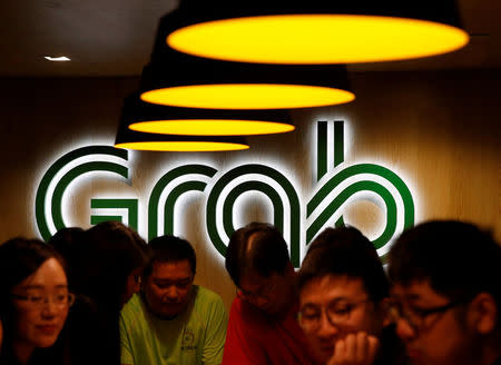 FILE PHOTO: New hires relax at a lounge area in a Grab office in Singapore September 23, 2016. REUTERS/Edgar Su/File Photo