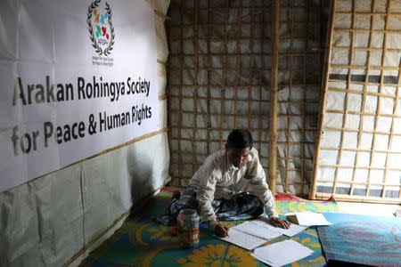 Mohib Bullah, a member of Arakan Rohingya Society for Peace and Human Rights, writes after collecting data about victims of a military crackdown in Myanmar, at Kutupalong camp in Cox's Bazar, Bangladesh, April 21, 2018. REUTERS/Mohammad Ponir Hossain