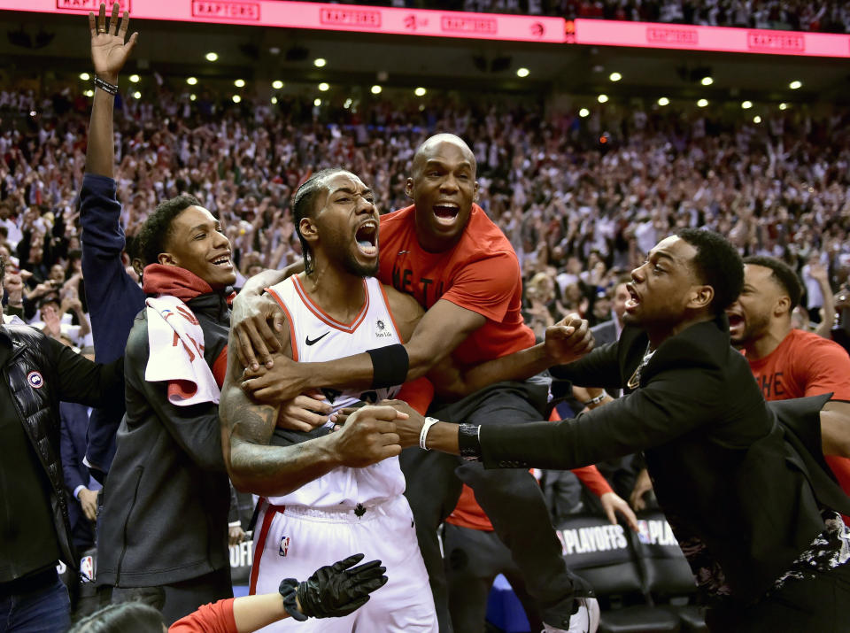 FILE - In this May 12, 2019, file photo, Toronto Raptors forward Kawhi Leonard, second from left, celebrates his game-winning basket as time expired at the end of an NBA Eastern Conference semifinal basketball game against the Philadelphia 76ers, in Toronto on Sunday,. Toronto won 92-90. (Frank Gunn/The Canadian Press via AP, File)