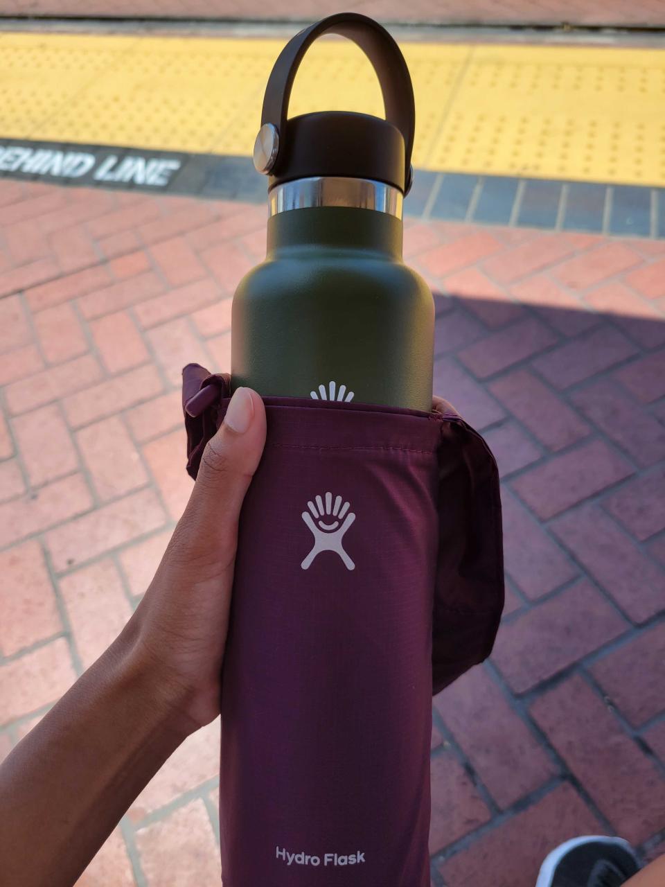 A Hydro Flask bottle and sling.