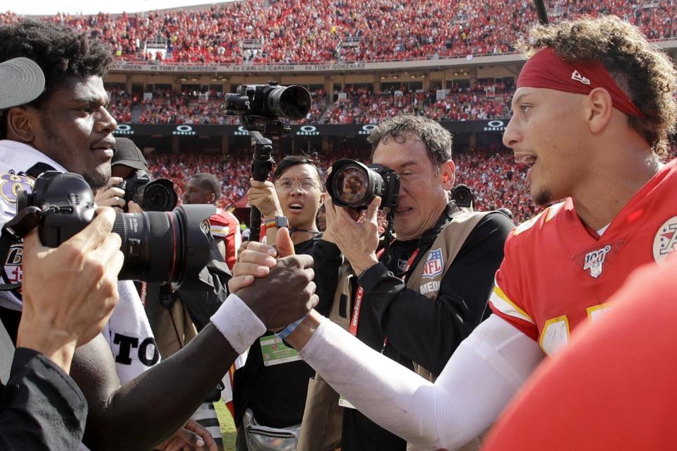 Chiefs quarterback Patrick Mahomes, right, and Ravens quarterback Lamar Jackson (8) greet each other with a handshake.