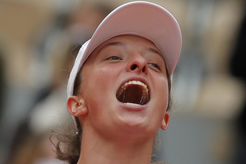 Poland's Iga Swiatek celebrates winning the final match of the French Open tennis tournament against Sofia Kenin of the U.S. in two sets, 6-4, 6-1, at the Roland Garros stadium in Paris, France, Saturday, Oct. 10, 2020. (AP Photo/Michel Euler)