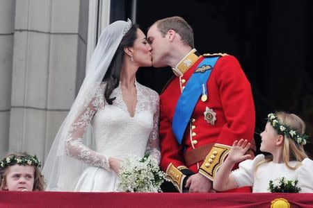 FILE PHOTO - Britain's Prince William and his wife Catherine, Duchess of Cambridge kiss on the balcony of Buckingham Palace, following following their wedding at Westminster Abbey in London April 29, 2011. REUTERS/John Stillwell/Pool