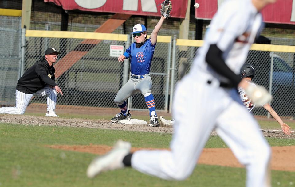 South Kitsap Wolves head coach Marcus Logue tells his player to slide into third during their game against Graham-Kapowsin in Port Orchard, on April 4, 2023.