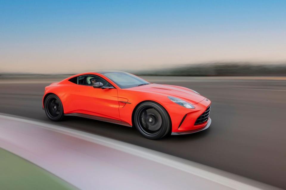 a red sports car driving on a road