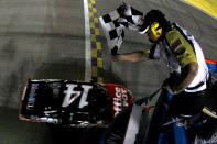 HOMESTEAD, FL - NOVEMBER 20: Tony Stewart, driver of the #14 Office Depot/Mobil 1 Chevrolet, crosses the finish line to win the NASCAR Sprint Cup Series Ford 400 and the 2011 Series Championship at Homestead-Miami Speedway on November 20, 2011 in Homestead, Florida. Stewart wins his third NASCAR Championship. (Photo by Todd Warshaw/Getty Images for NASCAR)