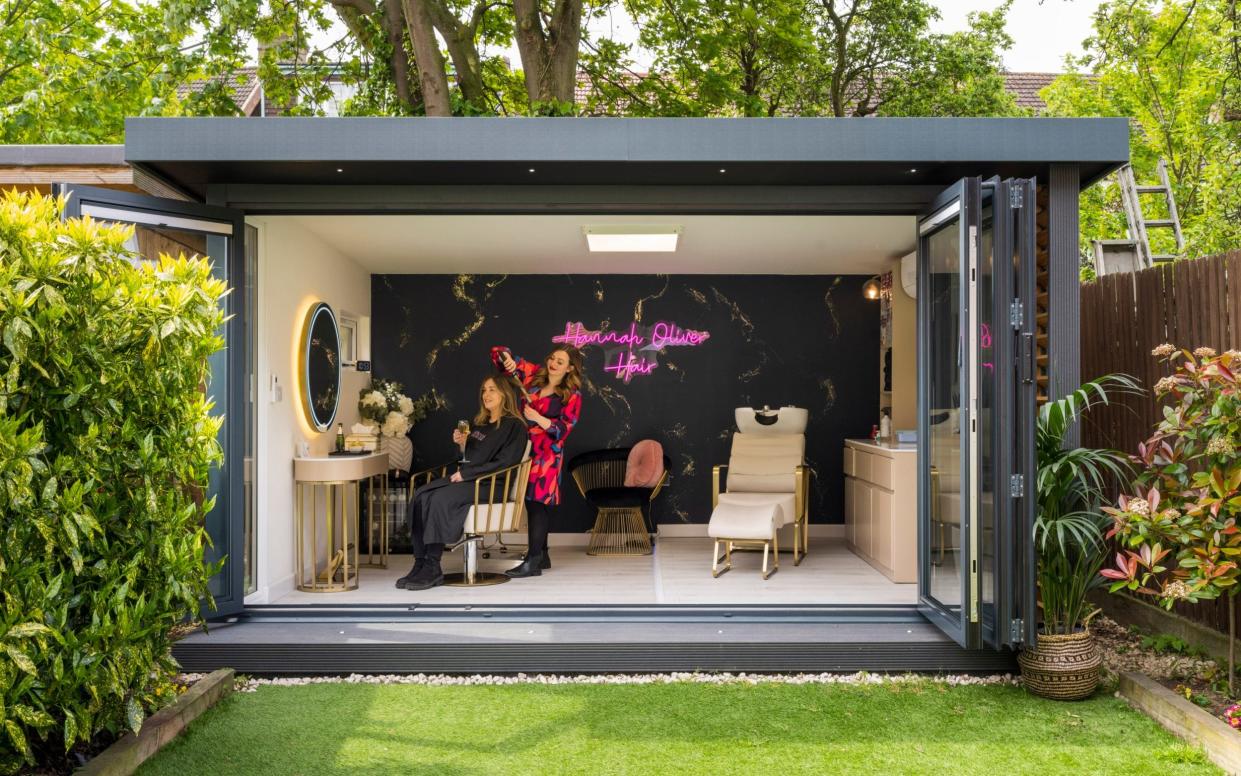 Hannah Oliver in her garden room, which she uses for her hairdressing business - Andrew Crowley