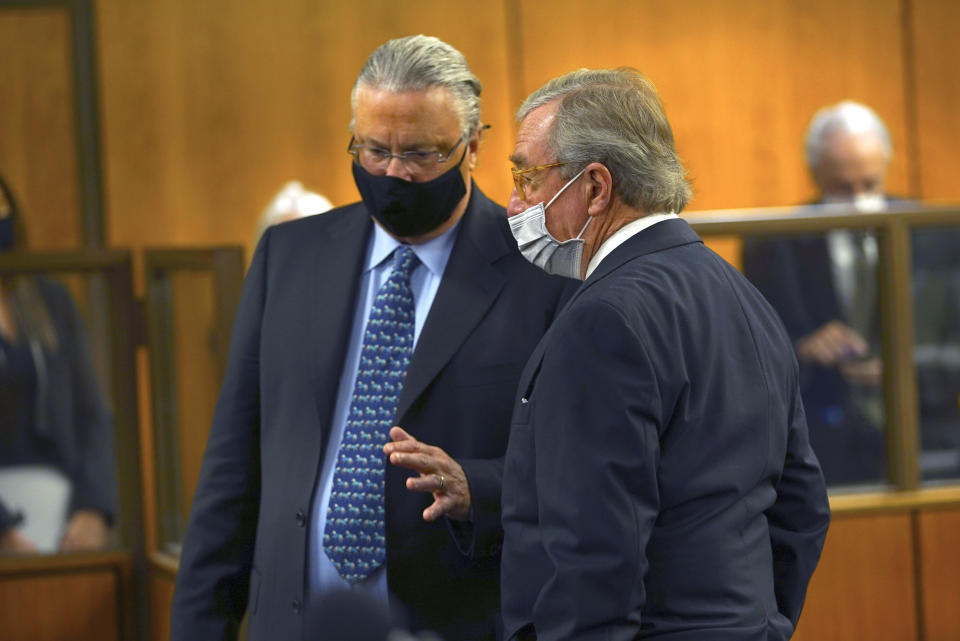 Defense attorneys David Z. Chesnoff, left, and Dick DeGuerin talk to each other during the murder trial of Robert Durst Monday, May 17, 2021, in Inglewood, Calif. The murder trial of the multimillionaire has resumed in Los Angeles County after a 14-month recess without the defendant present and with arguments about whether the case should continue at all. (Al Seib/Los Angeles Times via AP, Pool)
