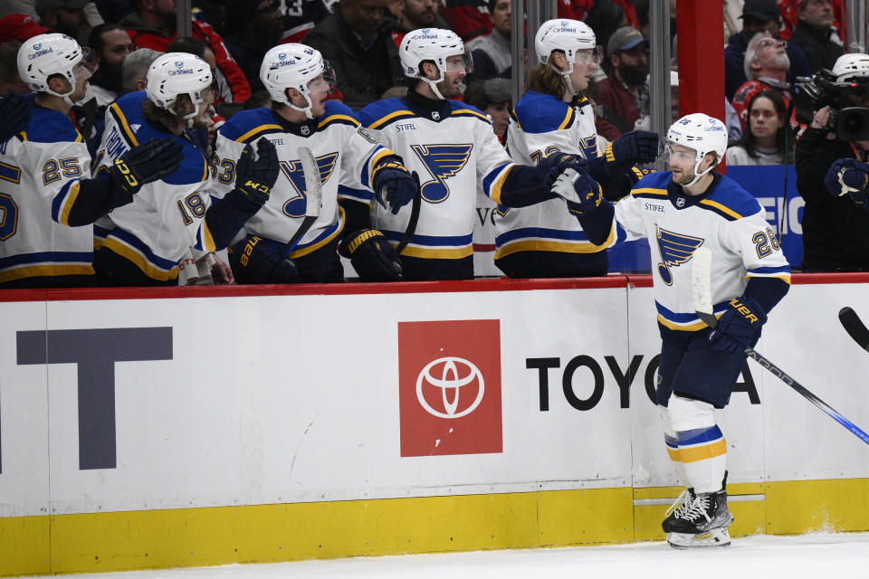 St. Louis Blues left wing Nathan Walker (26) is congratulated for his goal against the Washington Capitals during the first period of an NHL hockey game Thursday, Jan. 18, 2024, in Washington. (AP Photo/Nick Wass)