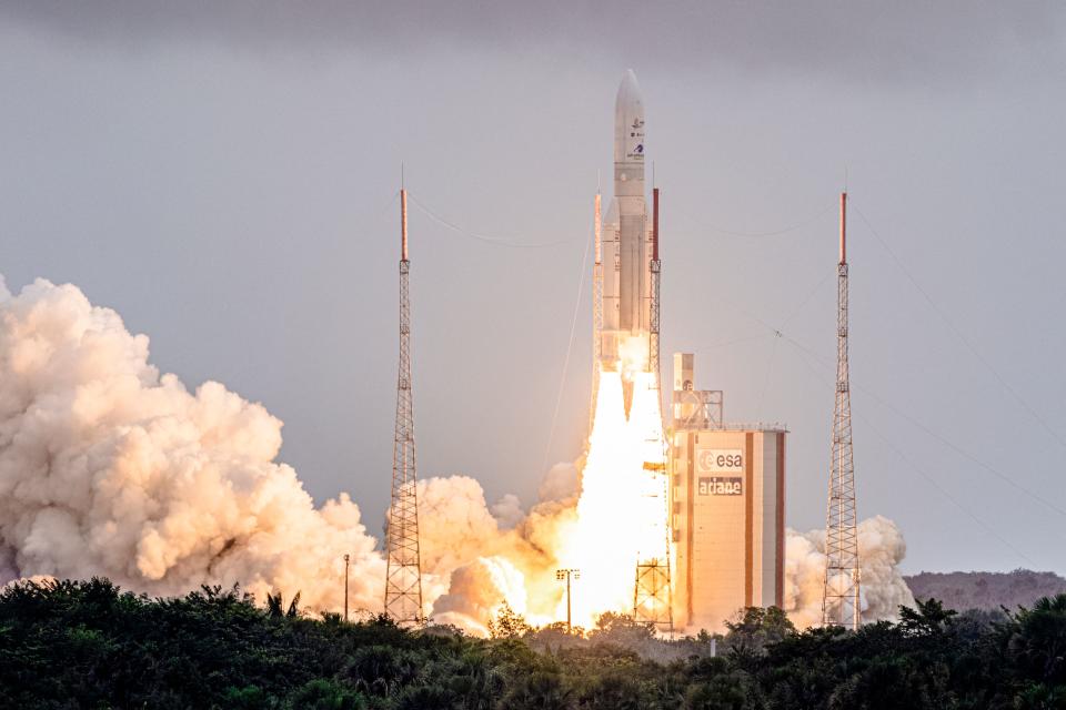 Arianespace's Ariane 5 rocket with NASAs James Webb Space Telescope onboard lifts up from the launchpad, at the Europes Spaceport, the Guiana Space Center in Kourou, French Guiana, on December 25, 2021. - The telescope, the most powerful space observatory ever built, is now tentatively set for launch on Christmas Day, after decades of waiting. An engineering marvel, it will help answer fundamental questions about the Universe, peering back in time 13 billion years. (Photo by jody amiet / AFP) (Photo by JODY AMIET/AFP via Getty Images)