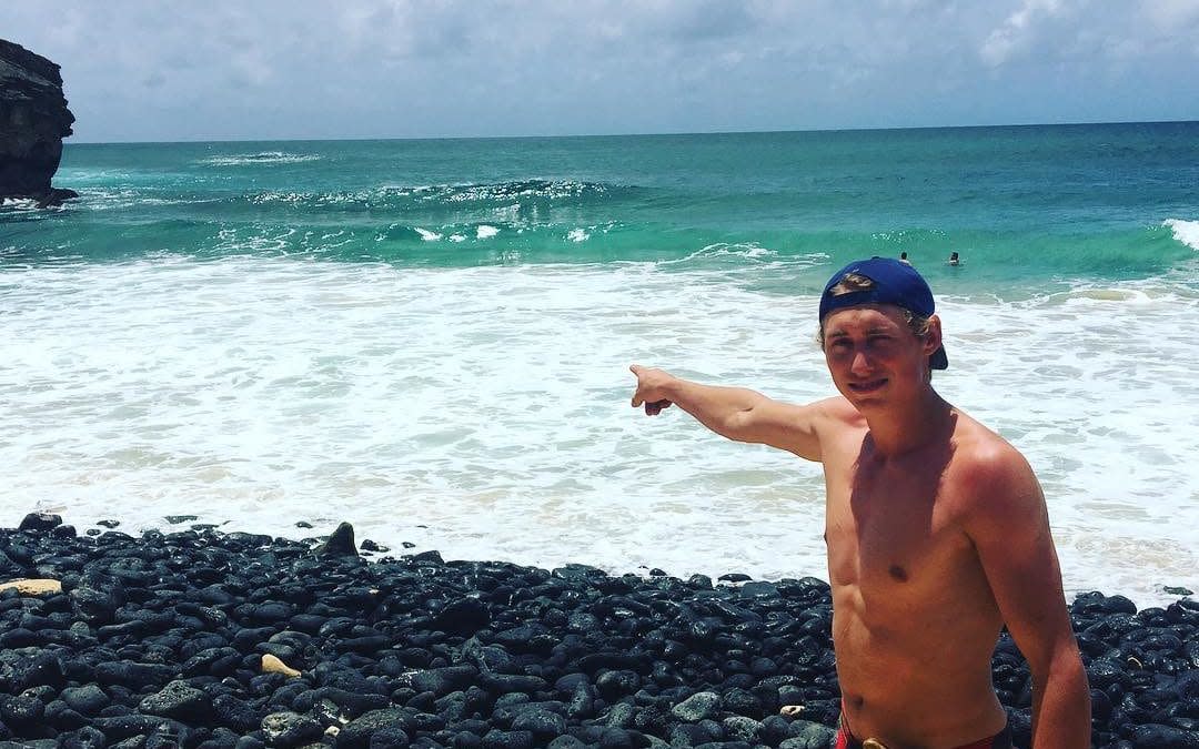 Dylan McWilliams, who has survived a snake, bear and shark attack points to the area in Hawaii where he was attacked and bitten by a shark - Dylan McWilliams