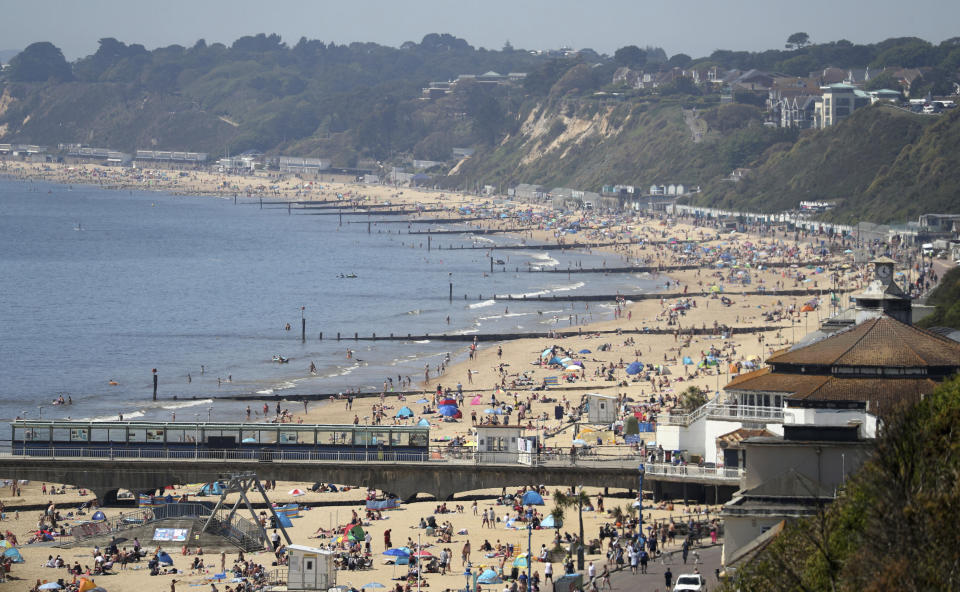 A view of Bournemouth beach on a sunny day, in Bournemouth, England, Wednesday May 20, 2020. Lockdown restrictions due to the coronavirus outbreak have been relaxed allowing unlimited outdoor exercise and activities such as sunbathing. (Andrew Matthews/PA via AP)