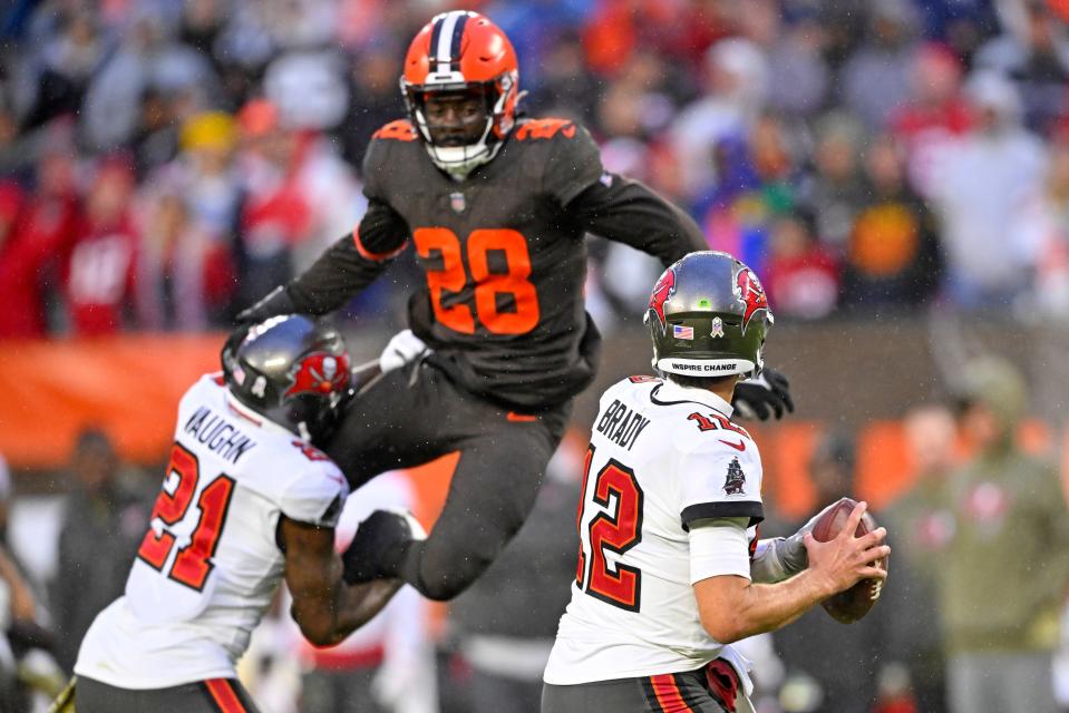 Buccaneers quarterback Tom Brady looks to pass with pressure coming from Browns linebacker Jeremiah Owusu-Koramoah Nov. 27, 2022, in Cleveland.