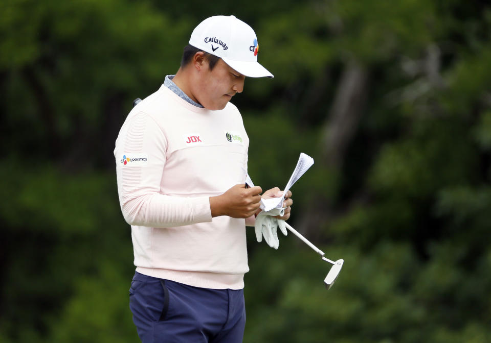 K.H. Lee, of South Korea, looks over his yardage book on the ninth green during the second round of the AT&T Byron Nelson golf tournament in McKinney, Texas, Friday, May 14, 2021. (AP Photo/Ray Carlin)