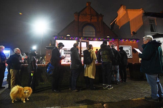 Voters queue outside a polling station (Victoria Jones/PA)