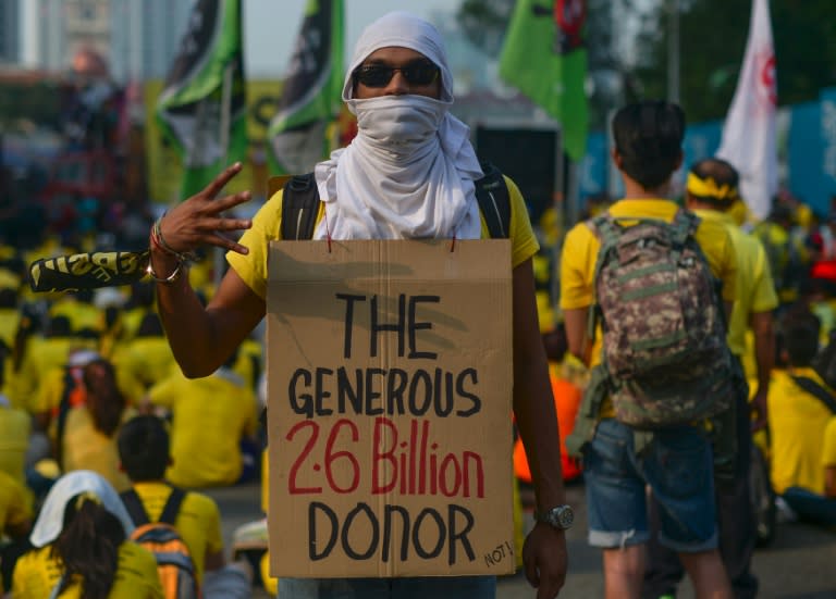 A protestor carries a placard on the second day of a demonstration demanding Prime Minister Najib Razak’s resignation and electoral reforms in Kuala Lumpur on August 30, 2015