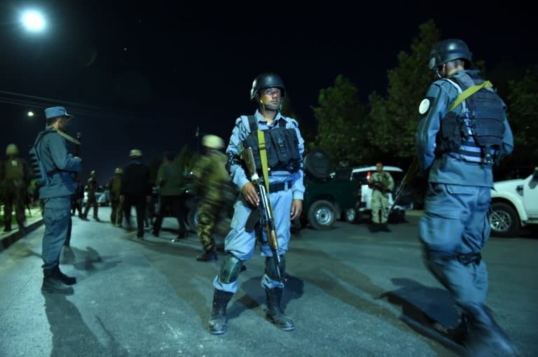 Afghan security personnel stand guard near the site of an explosion in Kabul on August 24, 2016