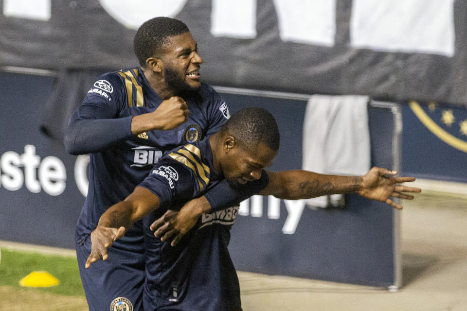 Philadelphia Union's Mark McKenzie, top, leaps upon teammate Cory Burke after he scored the go-ahead and eventual game-winning goal against the Chicago Fire during the second half of an MLS soccer match, Wednesday, Oct. 28, 2020, at Subaru Stadium in Chester, Pa. (Charles Fox/The Philadelphia Inquirer via AP)