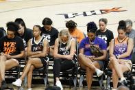 Phoenix Mercury players bow their heads in prayer at a rally for WNBA basketball teammate Brittney Griner Wednesday, July 6, 2022, in Phoenix. Griner has been detained in Russia for 133 days, charged in Russia for having vape cartridges containing hashish oil in her luggage. (AP Photo/Ross D. Franklin)