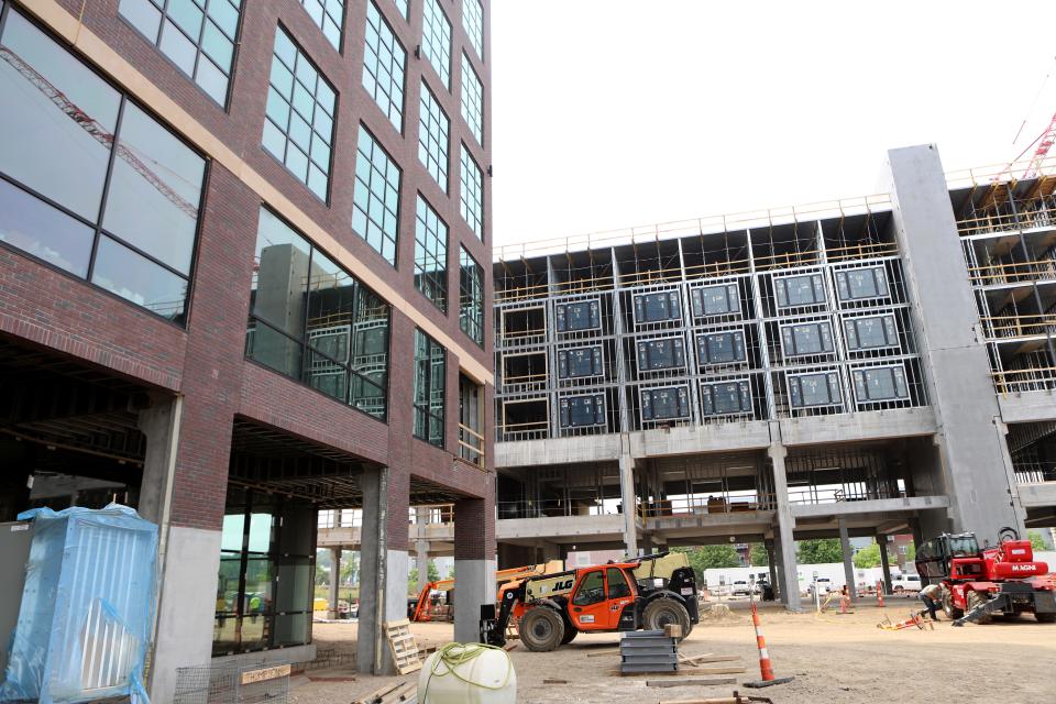A skywalk will eventually connect the Steel District office tower (left) to the Canopy by Hilton hotel. A pedestrian alley will sit between the office tower and the to-be-built convention center connected to the hotel to the right of this photo as seen on Friday, June 16.