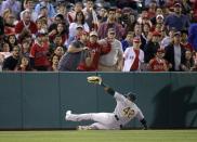 Oakland Athletics' Yoenis Cespedes misses a foul ball hit by Los Angeles Angels' Kole Calhoun during the second inning of a baseball game Tuesday, April 15, 2014, in Anaheim, Calif. (AP Photo/Jae C. Hong)