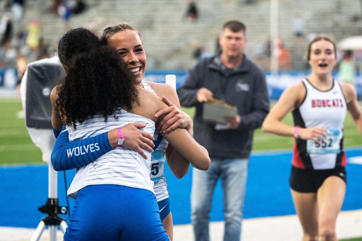 Waukee Northwest's Keziah Caldwell and Avery Winter hug after their team wins the 4x100 meter relay during the Drake Relays at Drake Stadium on Saturday, April 27, 2024, in Des Moines.