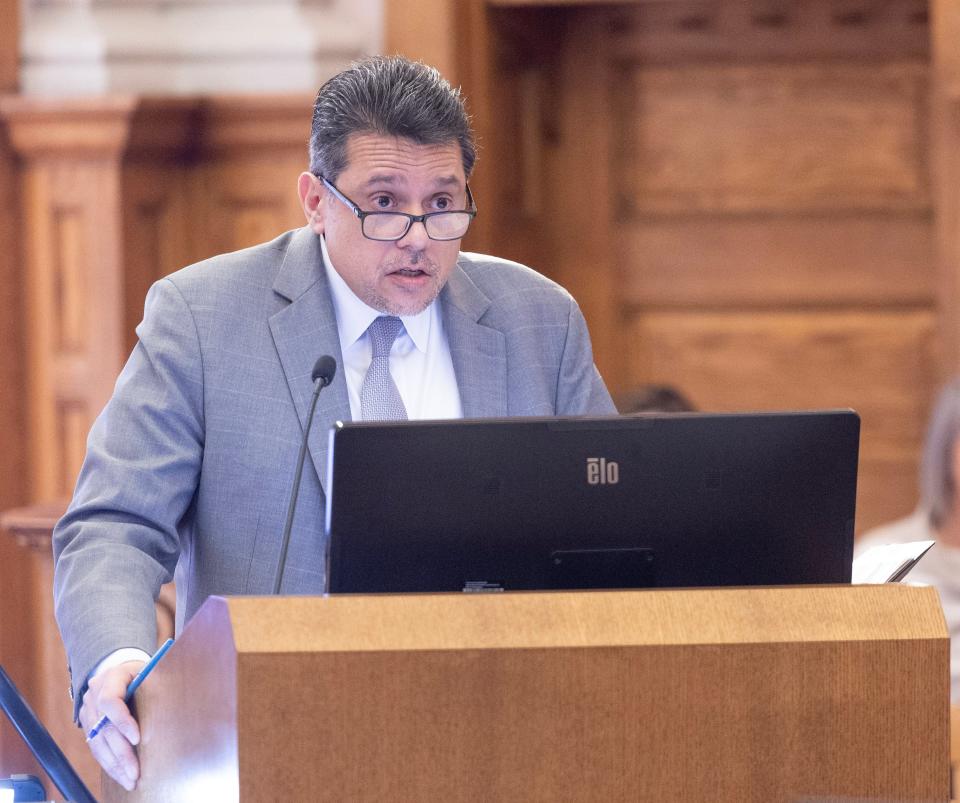 Defense attorney Anthony Koukoutas questions Steven Q. Troyer's widow, Glenda Troyer, in Judge Frank Forchione's courtroom during the trial of Damon Mitchell on Tuesday.