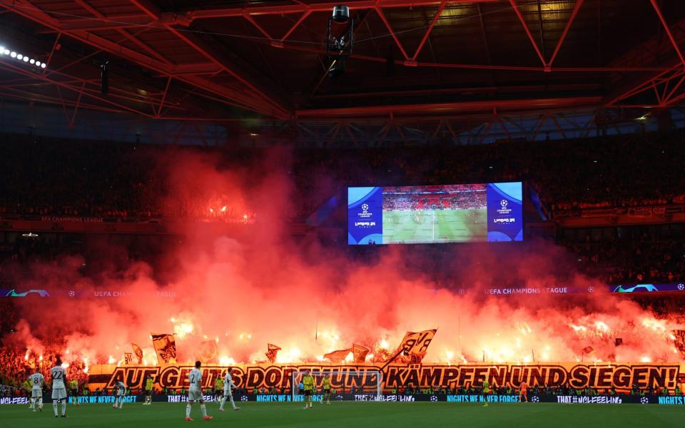 Borussia Dortmund fans let off flares during the UEFA Champions League 2023/24 final match between Borussia Dortmund v Real Madrid CF at Wembley Stadium on June 1, 2024 in London, England