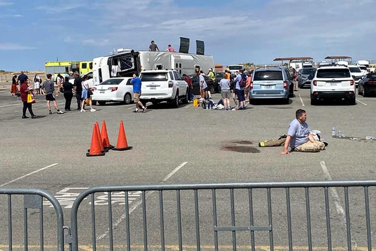 Emergency personnel tend to a crash after a tour bus rolled over in northern Arizona near the Grand Canyon West Skywalk on Aug. 1, 2023, in Peach Springs.