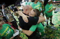 Oregon's Sabrina Ionescu, right, embraces head coach Kelly Graves after defeating Stanford in an NCAA college basketball game in the final of the Pac-12 women's tournament Sunday, March 8, 2020, in Las Vegas. (AP Photo/John Locher)
