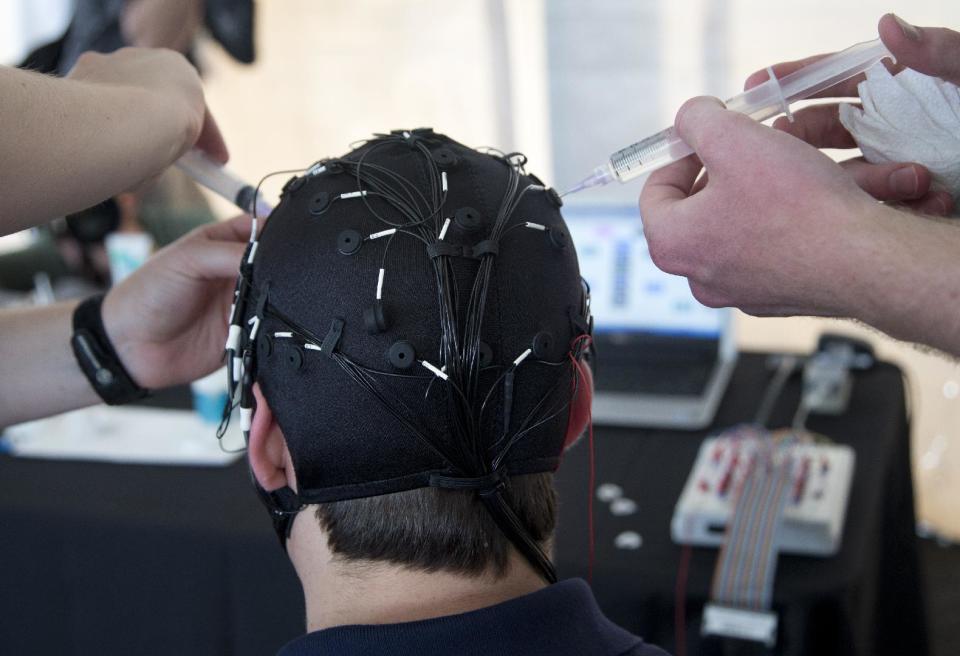 Russ Martin of American Automobile Association (AAA), is hooked to an electroencephalographic (EEG)-configured skull cap, during a demonstrations in support of their new study on distracted driving in Landover, Md., Tuesday, June 11, 2013. (AP Photo/Manuel Balce Ceneta)