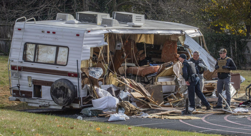 Police examine a stolen RV after ramming it multiple times with an armored vehicle while searching for a Marine deserter who is wanted for questioning in a murder case, in Roanoke, Va. (AP Photo/Don Petersen)
