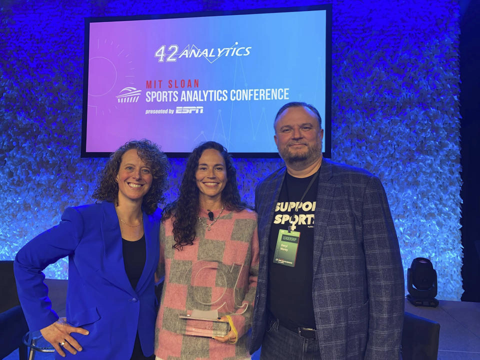 This March 2023 photo provided by the Sloan Sports Analytics Conference shows Sue Bird, center, posed with Jessica Gelman, left and Daryl Morley, right, after presenting Bird with the Lifetime Achievement Alpha Award at the 2023 Sloan Sports Analytics Conference in Boston. Jessica Gelman has become an influential leader and innovator in the sports industry. She co-founded the MIT Sloan Sports Analytics Conference. She teamed with Philadelphia 76ers President Daryl Morey to not only found Sloan, but guide it into the preeminent forum for number-crunchers. (Jeff Pinette/Sloan Sports Analytics Conference via AP)