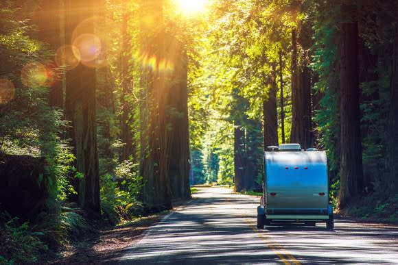 RV trailer being towed on the Redwood Highway in California.