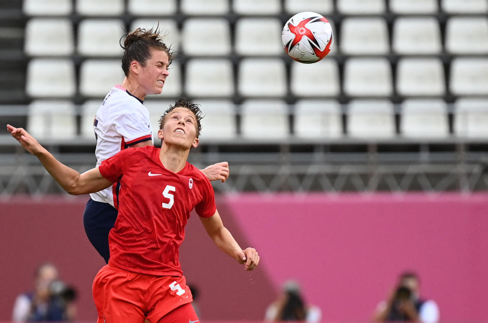 Canada's midfielder Quinn, right, blazed a trail for nonbinary visibility during the Tokyo 2020 Olympic Games. (Photo: MARTIN BERNETTI/AFP via Getty Images)