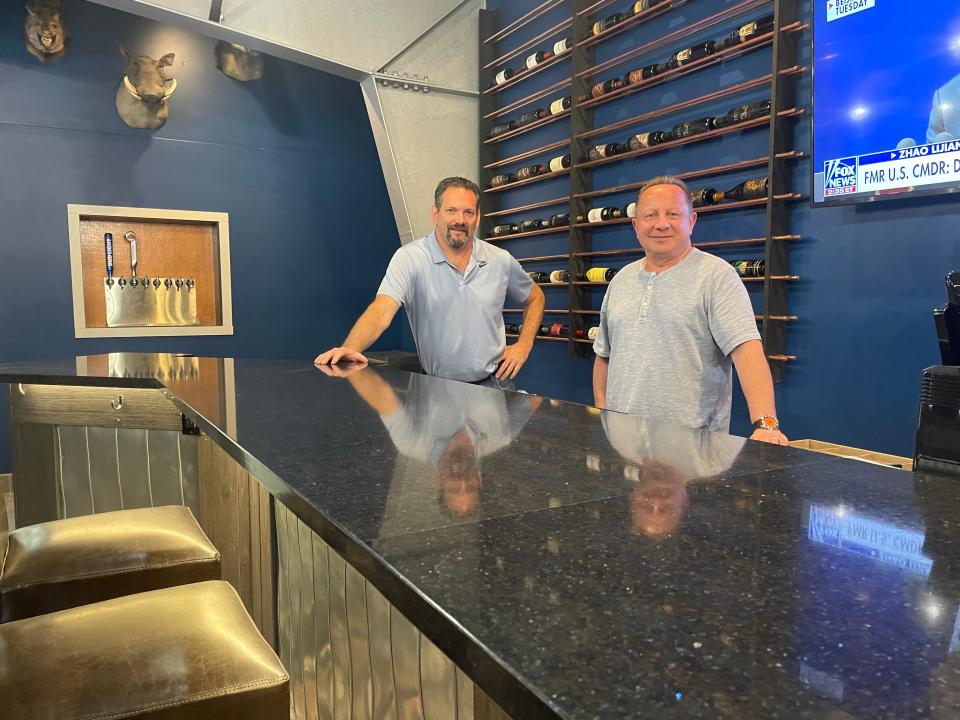 The Canopy Lounge co-owners, Bill Opre, left, and John Kallabat ,shown Thursday, June 9, 2022, are putting finishing touches on the new bar and restaurant in Brighton, which includes beer taps set into a wall and a wine rack behind a 30-person bar.