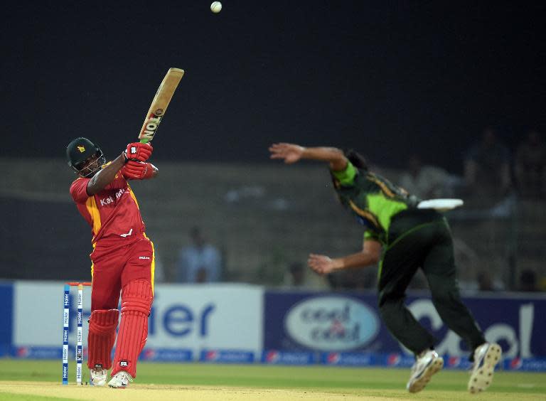 Zimbabwe batsman Hamilton Masakadza (L) hits a shot during the first international T20 match between Pakistan and Zimbabwe at the Gaddafi Cricket Stadium in Lahore on May 22, 2015