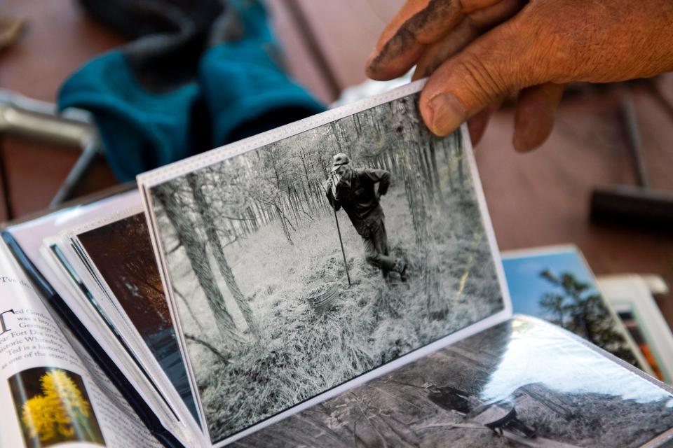Bill Wasiowich, 83, flips through an old photo album of himself from the 1980s in the Pinelands of Woodmansie, New Jersey.