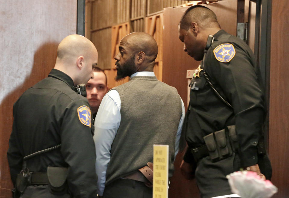 Hanif Thompson, 29, center, one of four accused in the Dec. 15, 2013, carjacking at The Mall at Short Hills, where Dustin Friedland, of Hoboken, was fatally shot as he returned with his wife to their vehicle, looks back after appearing for an arraignment hearing at Essex County Superior Court, Wednesday, Jan. 8, 2014, in Newark, N.J. Karif Ford, 31, Basim Henry, 32, and Kevin Roberts, 33, were also charged during the morning arraignment. All four pleaded not guilty. Each has been charged with murder, felony murder, carjacking, conspiracy, possession of a weapon and possession of a weapon for unlawful purpose. (AP Photo/Julio Cortez)