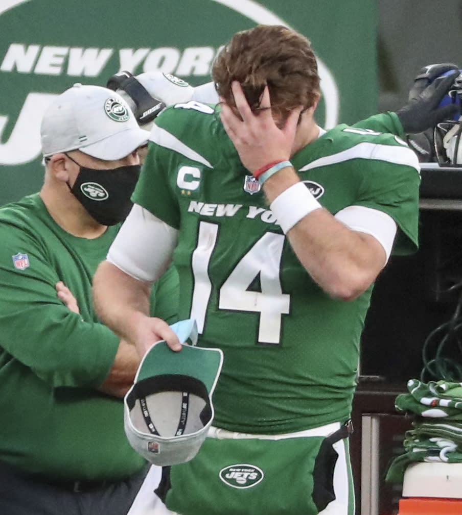 New York Jets quarterback Sam Darnold (14) puts on a cap after he threw an interception, his second of the game, in the fourth quarter against the Miami Dolphins on Sunday, Nov. 29, 2020, in East Rutherford, N.J. (Andrew Mills/NJ Advance Media via AP)