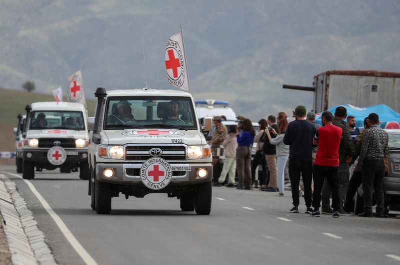 ICRC cars drive past an Armenian checkpoint near Kornidzor
