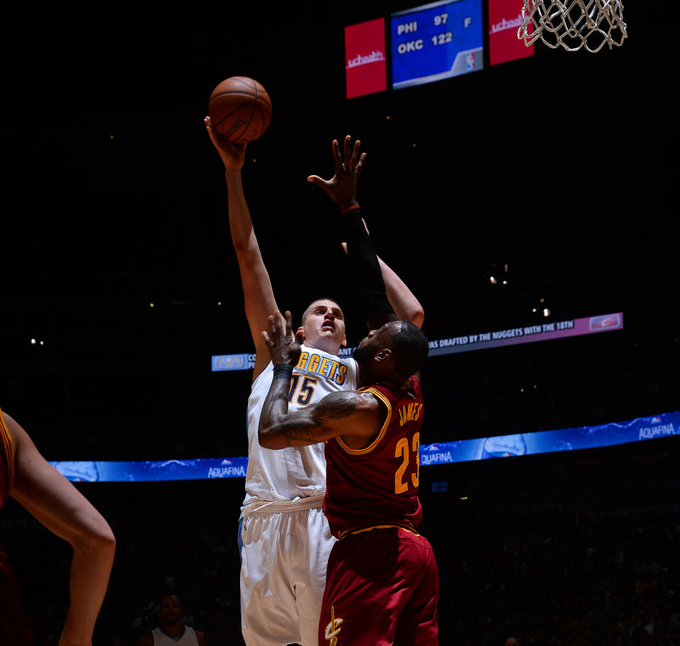 Nikola Jokic lets one go over the outstretched arm of LeBron James. (Getty Images)